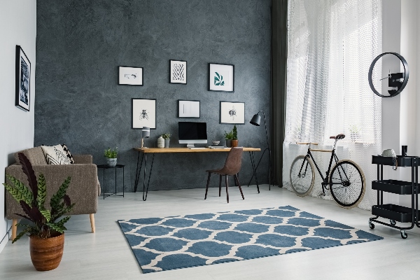 An area rug can tie the room together while not covering the entire room like carpeting.